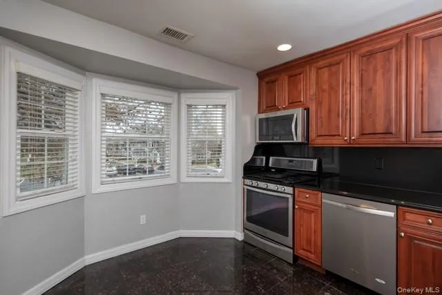 a kitchen with wooden cabinets and a stove top oven