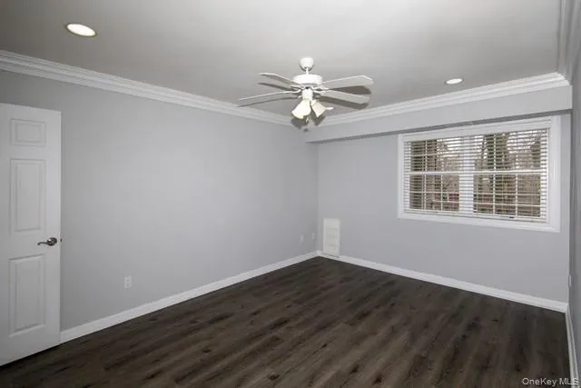 a view of a room with wooden floor and windows