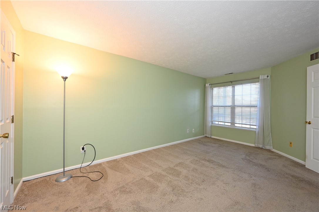 28140 Detroit Road, Unit A1 Westlake, OH 44145 - Photo 17 of 30 Empty room with a textured ceiling and carpet