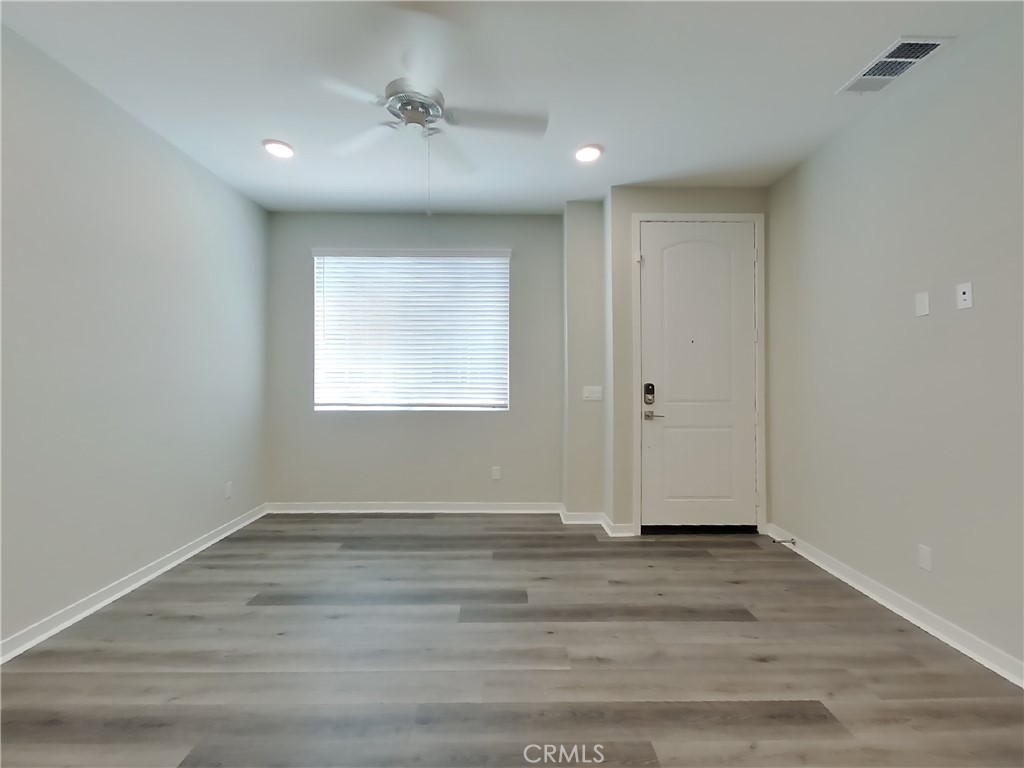 24931 Padre Court Wildomar, CA 92595 - Photo 2 of 24 a view of wooden floor and windows in a room