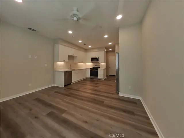 a view of kitchen and kitchen with furniture wooden floor and window