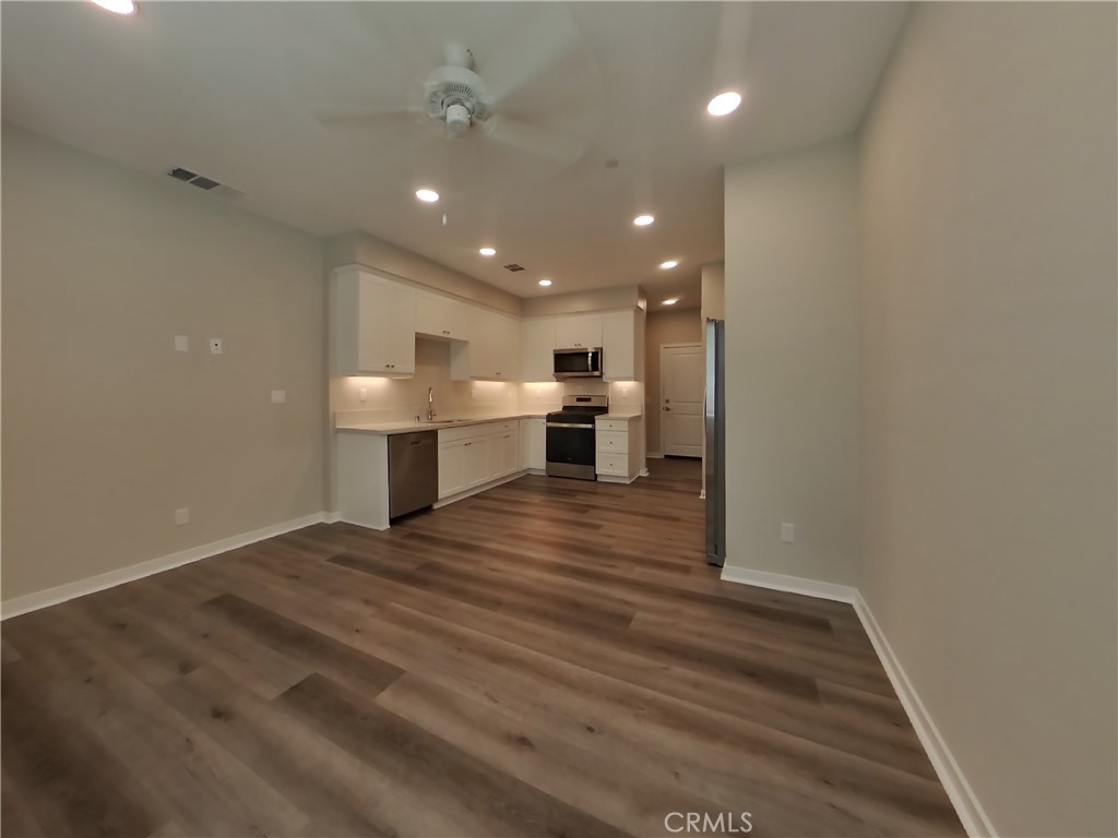 24931 Padre Court Wildomar, CA 92595 - Photo 3 of 24 a view of kitchen and kitchen with furniture wooden floor and window
