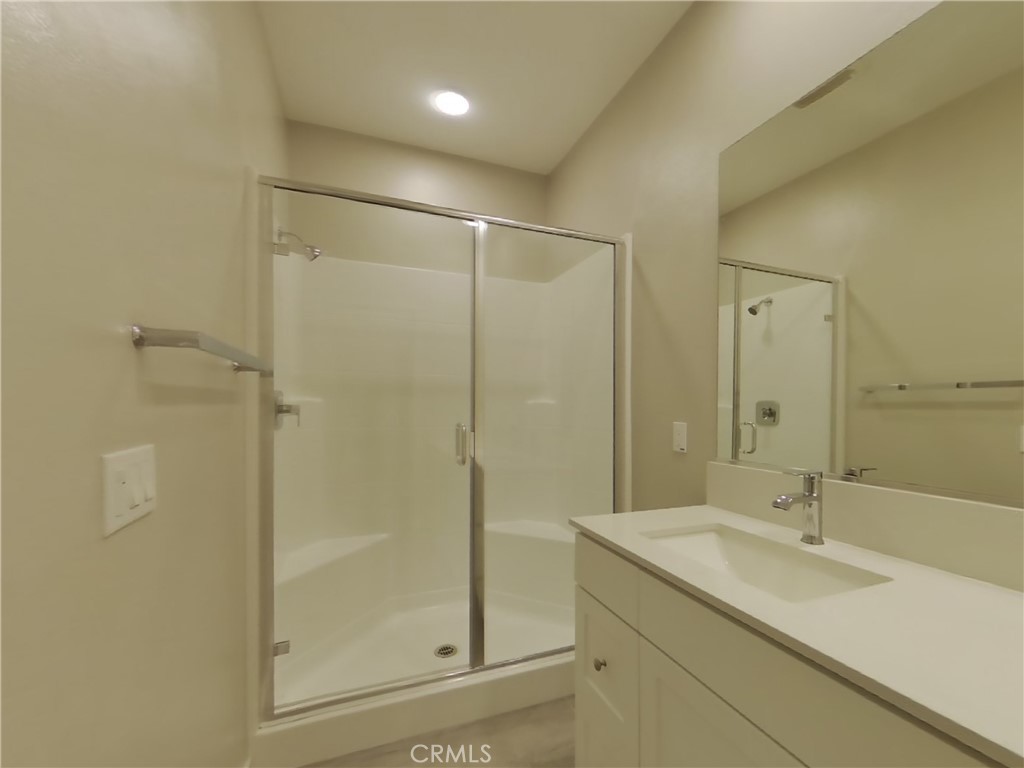 24931 Padre Court Wildomar, CA 92595 - Photo 8 of 24 a bathroom with a shower sink and mirror