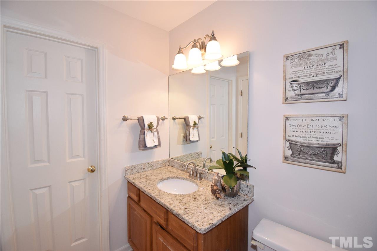 6710 Twin Tree Court Raleigh, NC 27613 - Photo 11 of 18 a bathroom with a granite countertop sink and a mirror
