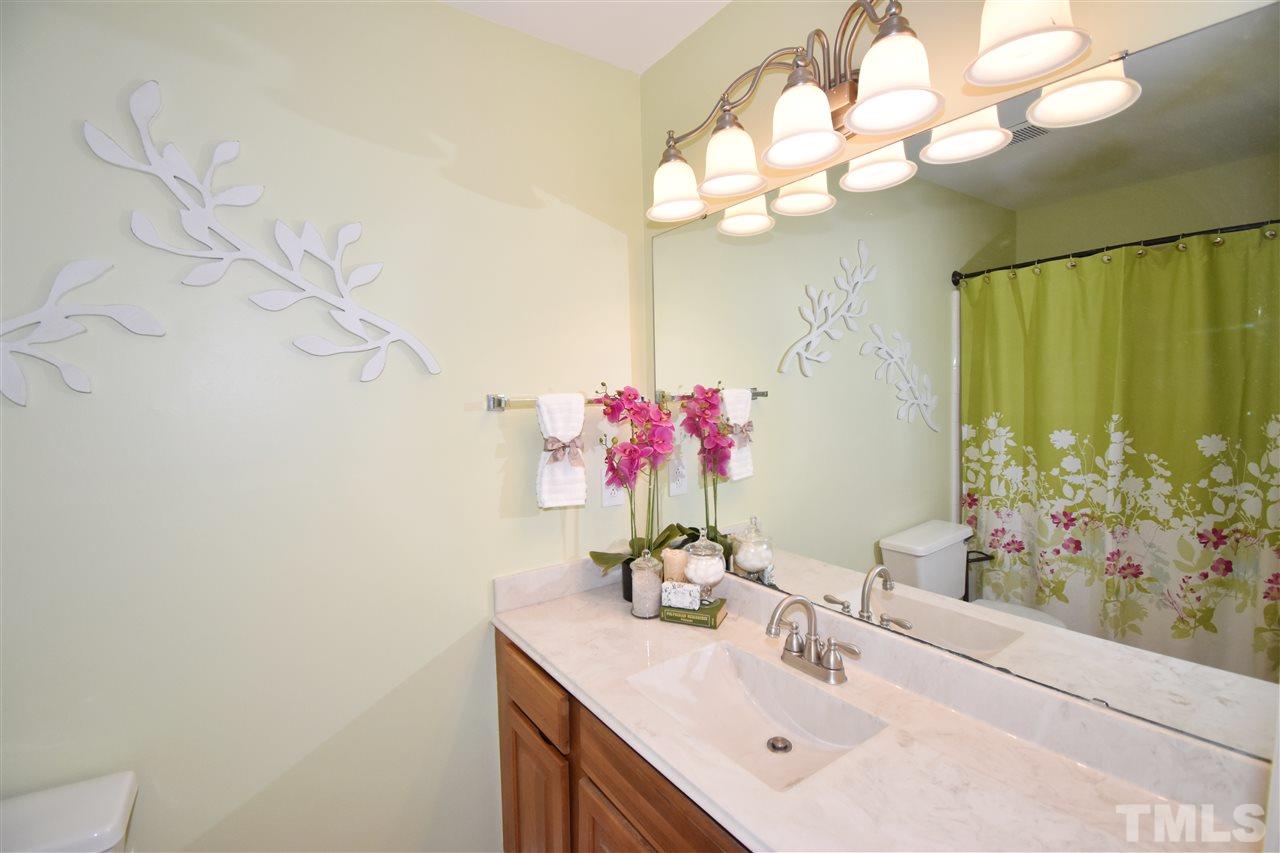 6710 Twin Tree Court Raleigh, NC 27613 - Photo 14 of 18 a bathroom with a sink vanity and a mirror