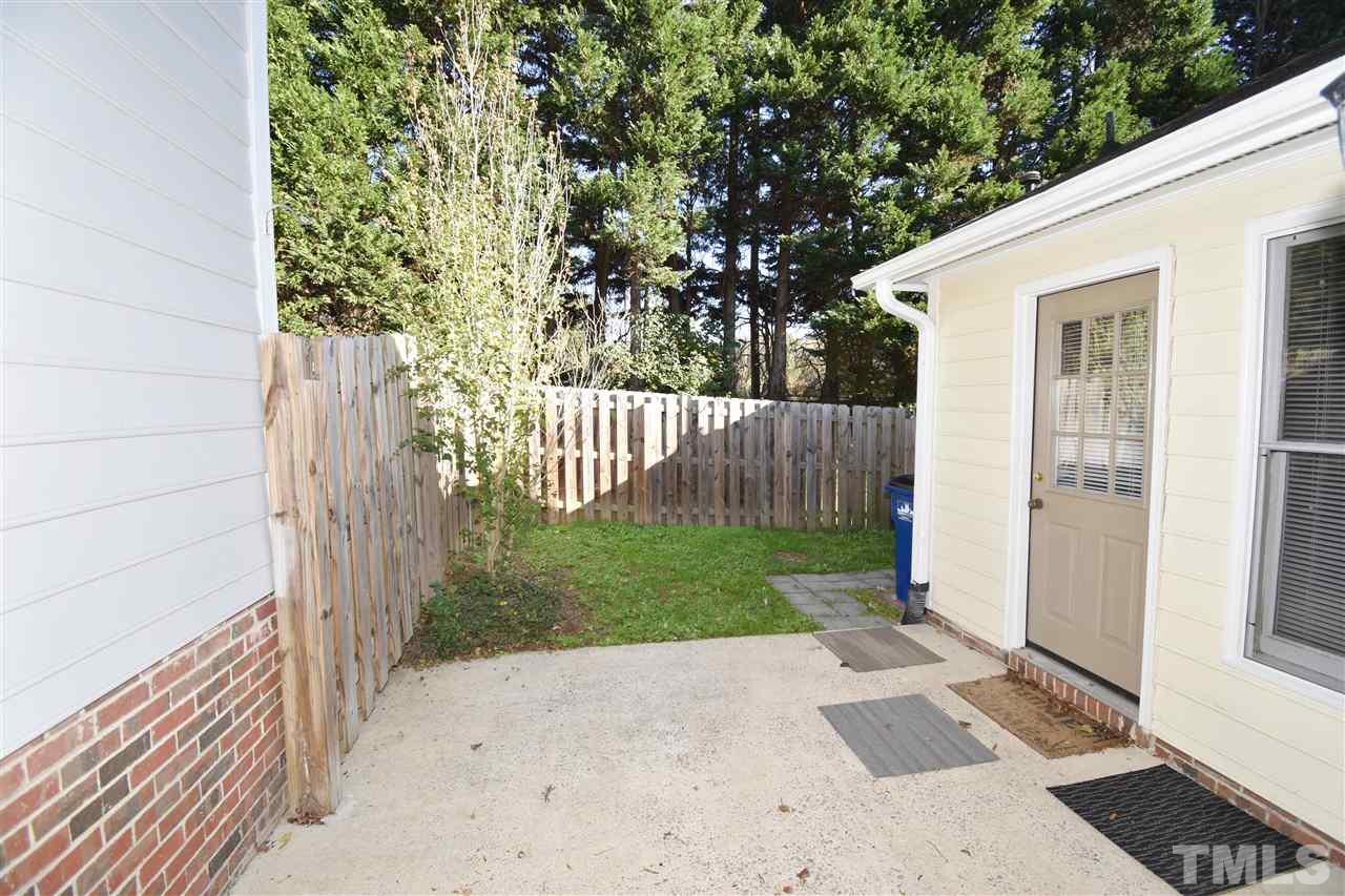 6710 Twin Tree Court Raleigh, NC 27613 - Photo 18 of 18 a view of a yard with wooden fence