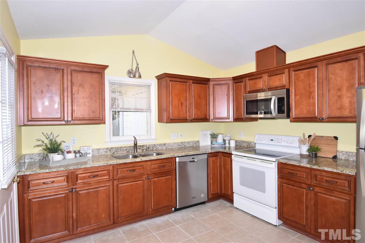 6710 Twin Tree Court Raleigh, NC 27613 - Photo 3 of 18 a kitchen with stainless steel appliances granite countertop a sink stove and cabinets