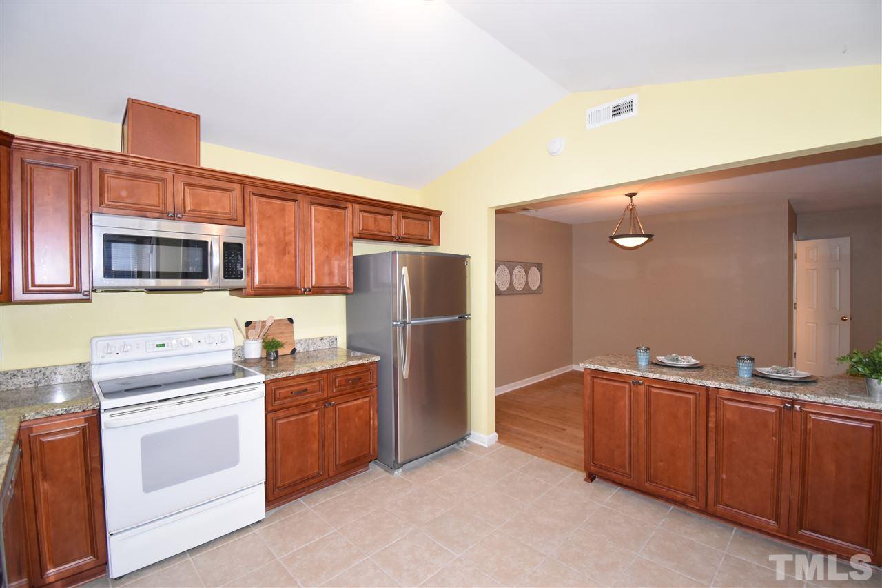 6710 Twin Tree Court Raleigh, NC 27613 - Photo 4 of 18 a kitchen with stainless steel appliances a refrigerator stove and sink