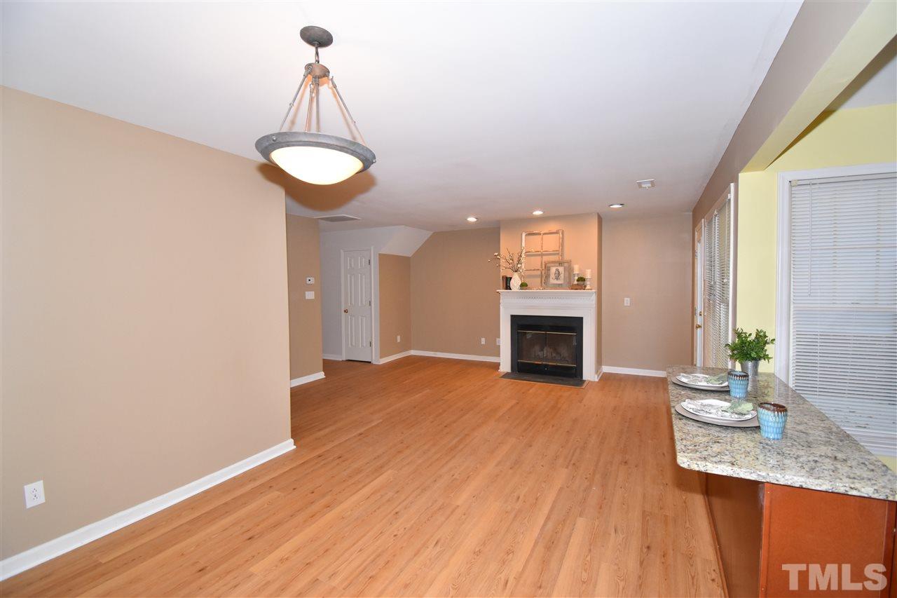 6710 Twin Tree Court Raleigh, NC 27613 - Photo 5 of 18 a view of a kitchen with a sink and a chandelier