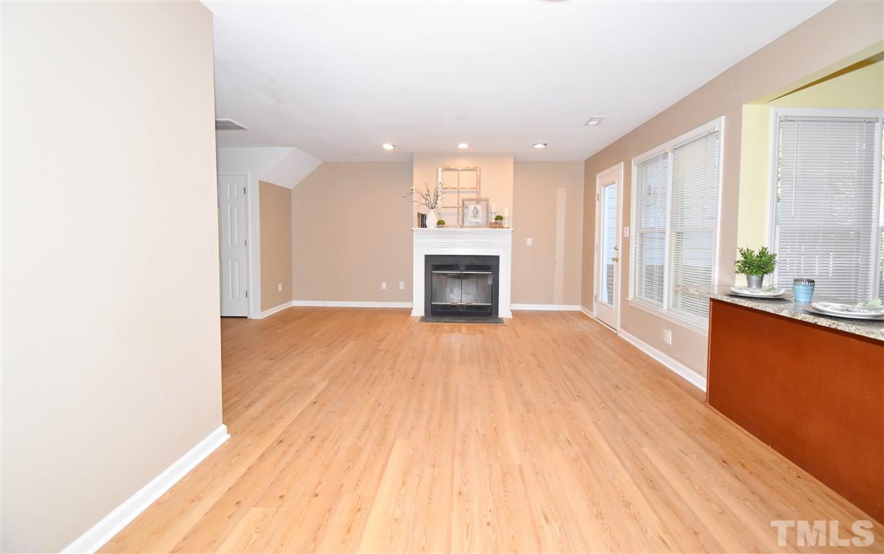 6710 Twin Tree Court Raleigh, NC 27613 - Photo 6 of 18 a view of empty room with a kitchen and a window