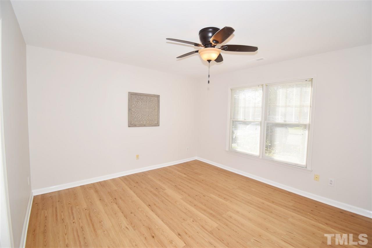 6710 Twin Tree Court Raleigh, NC 27613 - Photo 9 of 18 a view of empty room with wooden floor and fan