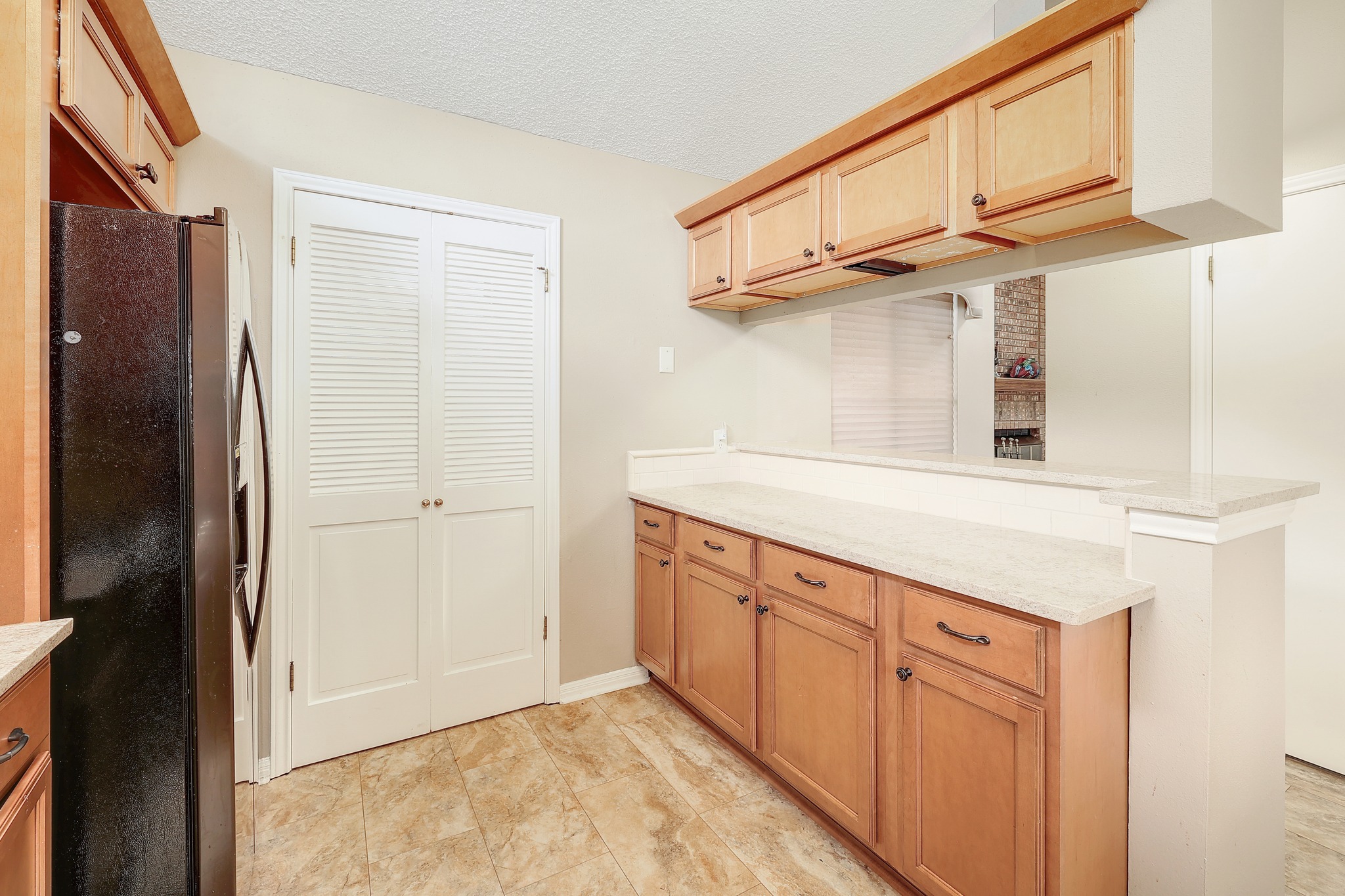 2202 Warfield Way Austin, TX 78728 - Photo 11 of 32 An inviting kitchen features warm cabinetry, plentiful counter space, and durable tiled flooring.