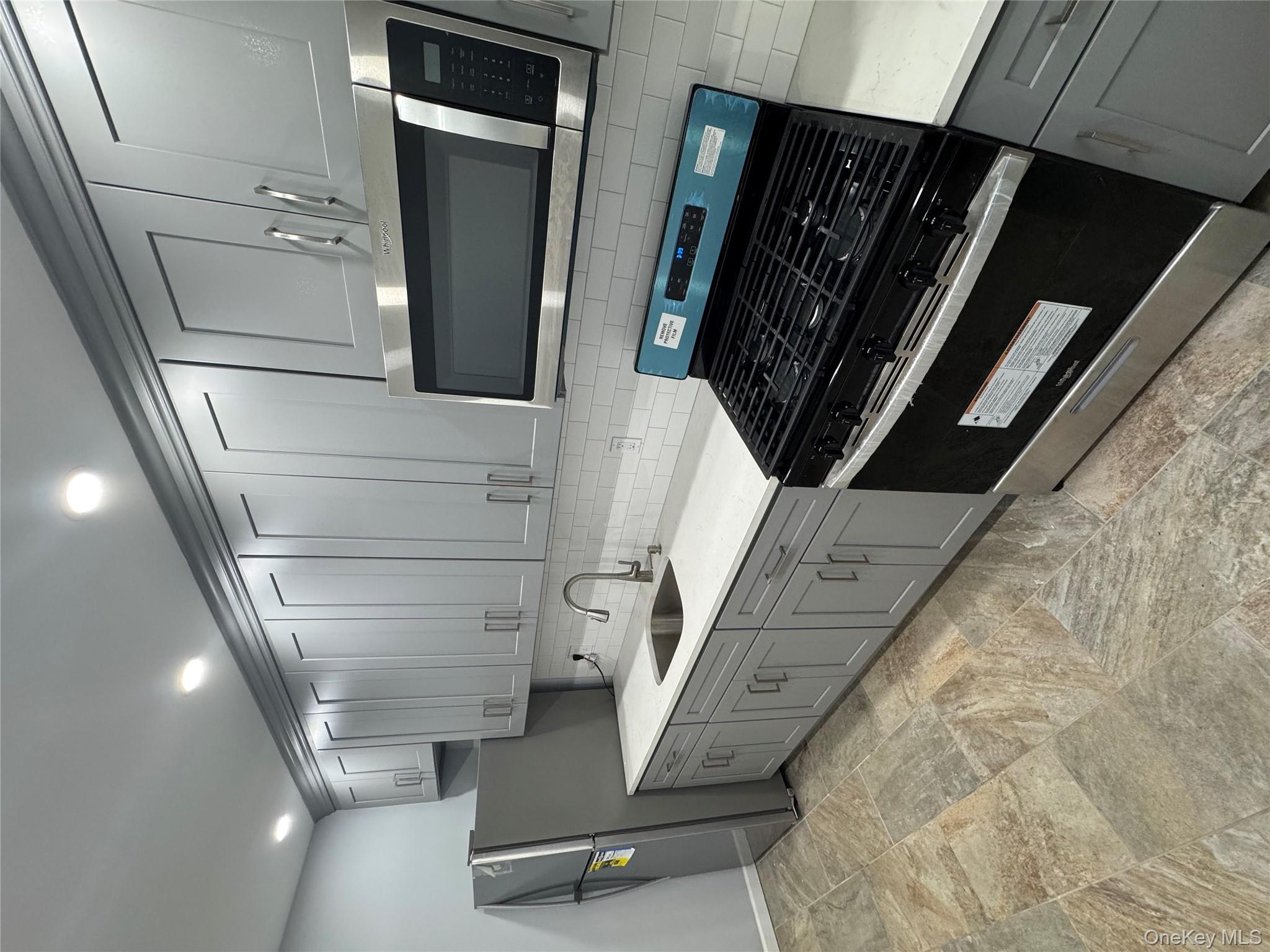 a kitchen with a stove and a microwave