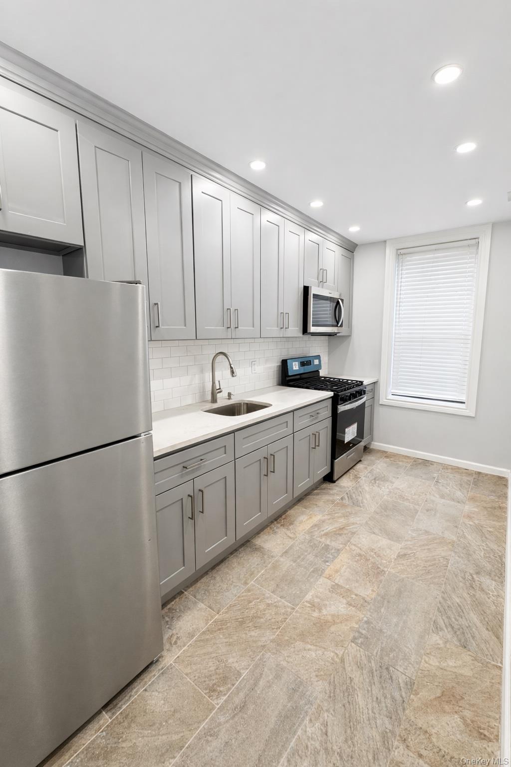 a kitchen with stainless steel appliances granite countertop a refrigerator sink and cabinets