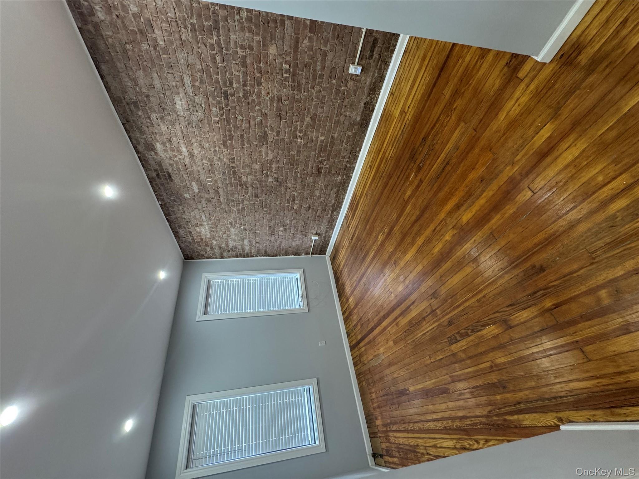 299 Malcolm X Boulevard Brooklyn, NY 11233 - Photo 2 of 9 a view of an empty room with wooden floor