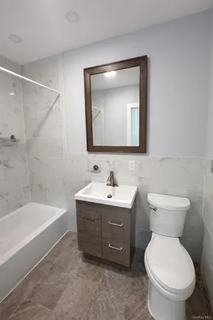 a bathroom with a toilet sink and bathtub