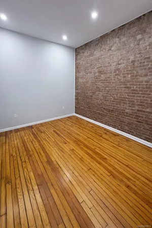 a view of wooden floor and brick walls