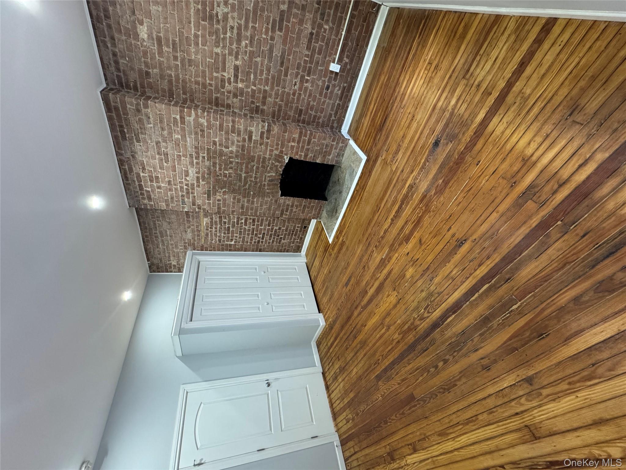 299 Malcolm X Boulevard Brooklyn, NY 11233 - Photo 7 of 9 a view of empty room with wooden floor