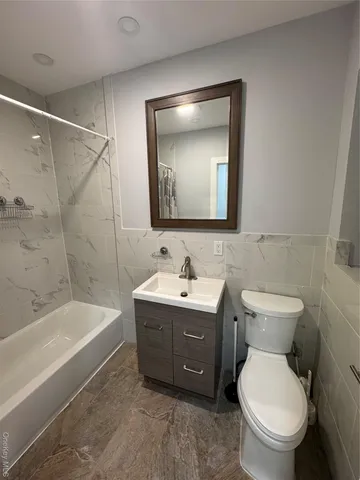 a bathroom with a toilet a sink and bathtub