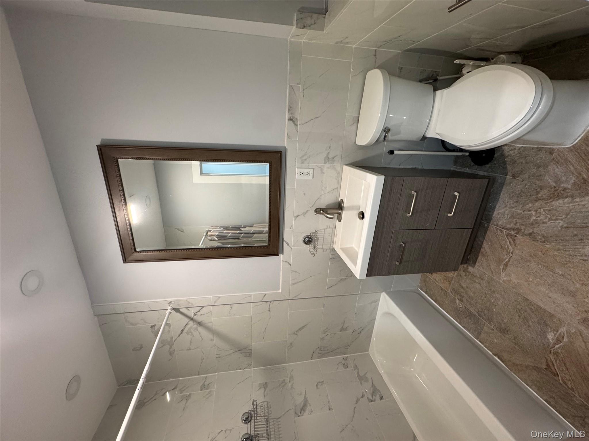 299 Malcolm X Boulevard Brooklyn, NY 11233 - Photo 9 of 9 a bathroom with a toilet a sink and bathtub