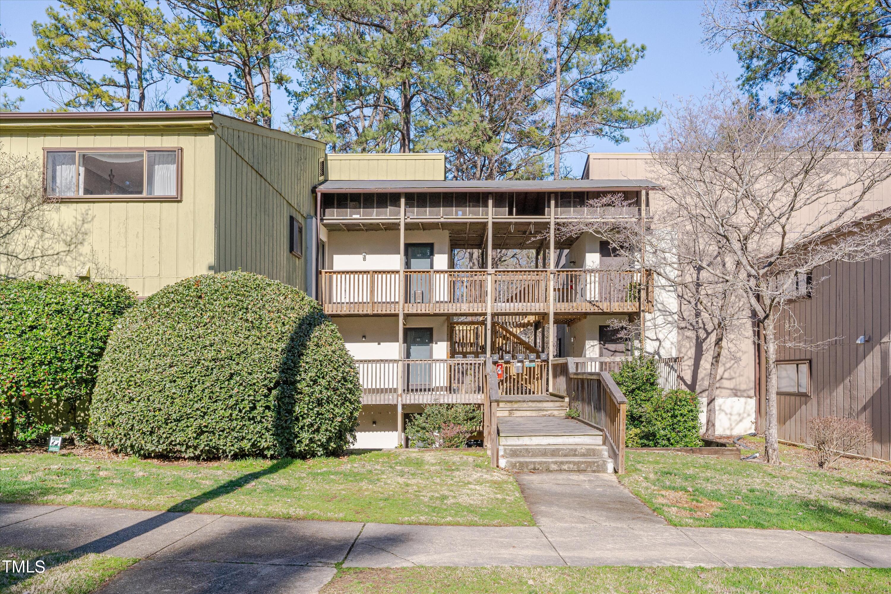 617 Pine Ridge Place Raleigh, NC 27609 - Photo 2 of 18 a front view of a house with a garden