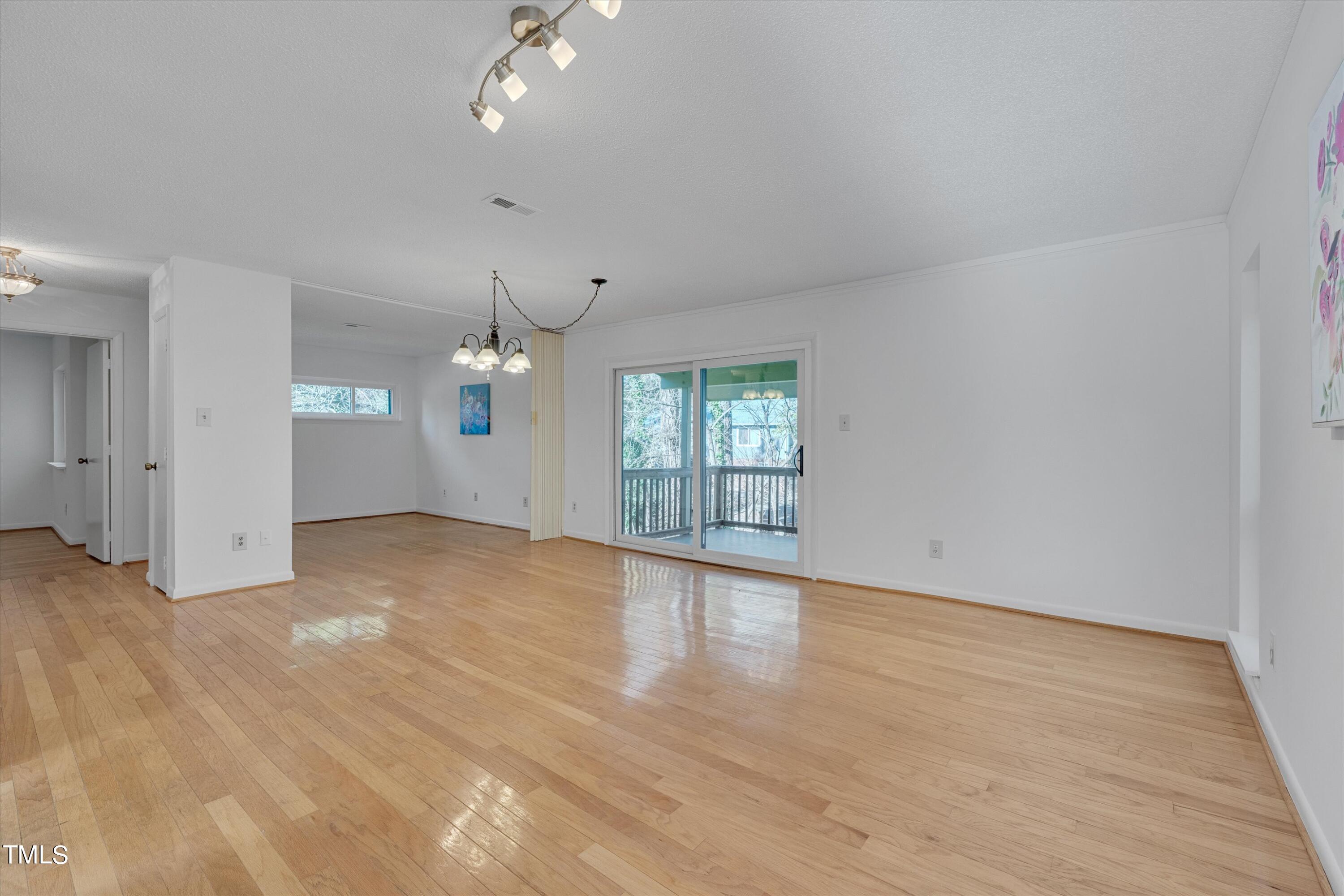 617 Pine Ridge Place Raleigh, NC 27609 - Photo 7 of 18 wooden floor in an empty room with a window