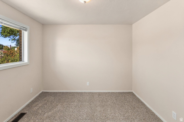 15295 North 5400th Street West Riverside, UT 84334 - Photo 18 of 54 Neutral wall paint with textured carpeting and a single window