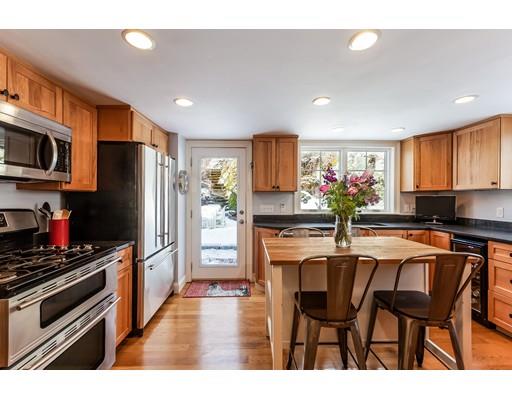 238 Hale Street Beverly, MA 01915 - Photo 2 of 30 a kitchen with stainless steel appliances a refrigerator a stove a dining table and chairs