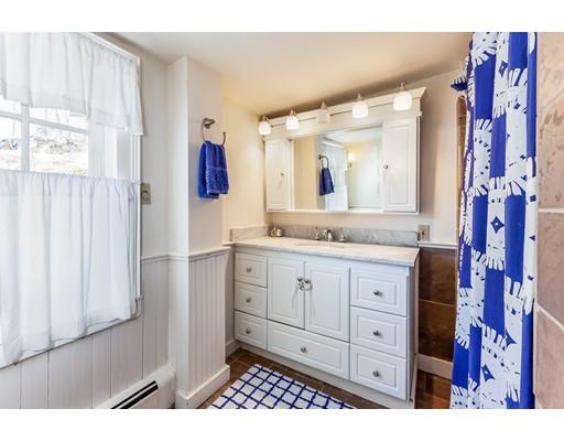 238 Hale Street Beverly, MA 01915 - Photo 22 of 30 a bathroom with a granite countertop sink a mirror and shower