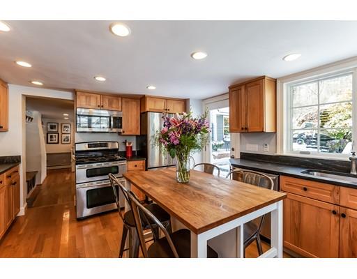 238 Hale Street Beverly, MA 01915 - Photo 3 of 30 a kitchen with stainless steel appliances granite countertop a kitchen island hardwood floor sink stove dining table and chairs