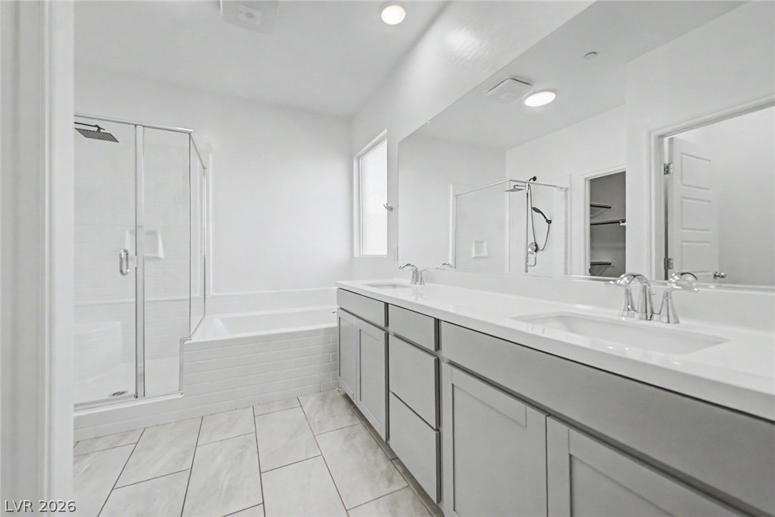 226 Augusta Ridge Henderson, NV 89015 - Photo 13 of 47 Bright and clean, this primary bathroom features a double vanity and sleek fixtures.