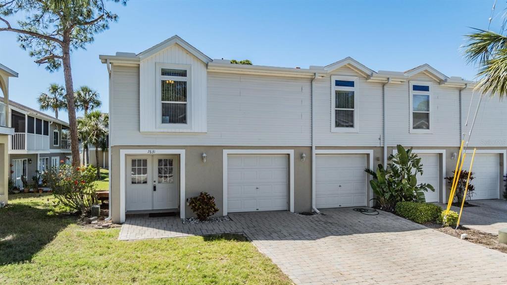 7631 Sailwinds Pass Port Richey, FL 34668 - Photo 1 of 1 a view of a front of house with a yard
