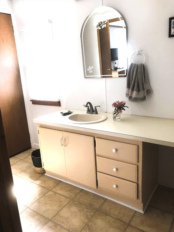 41 Pipers Way Carver, MA 02330 - Photo 25 of 36 a bathroom with a sink and a mirror