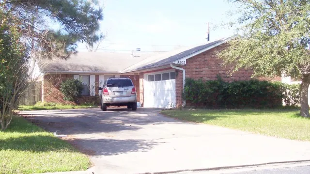 a front view of a house with a garden and pathway