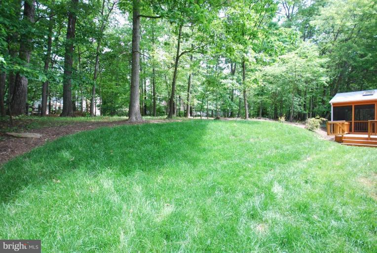 10728 Midsummer Drive Reston, VA 20191 - Photo 2 of 21 a view of a yard with a house in the background