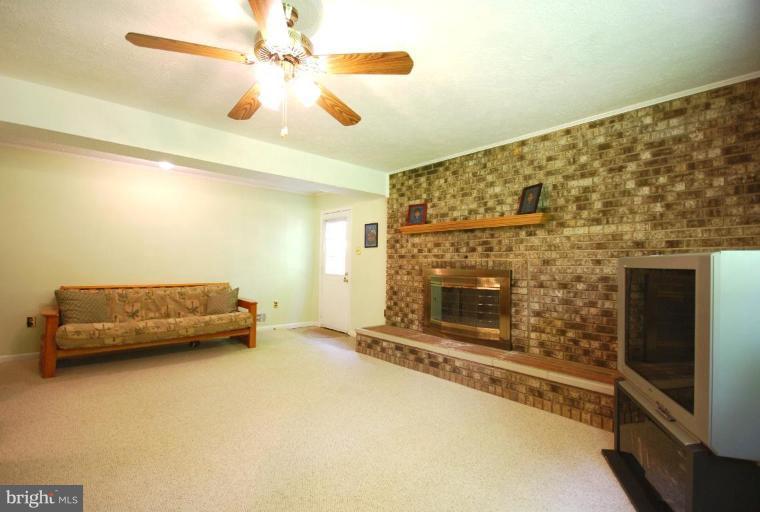 10728 Midsummer Drive Reston, VA 20191 - Photo 13 of 21 a living room with furniture and a fireplace