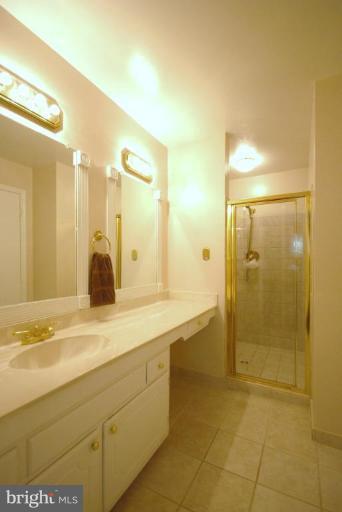 10728 Midsummer Drive Reston, VA 20191 - Photo 15 of 21 a bathroom with a granite countertop sink mirror and shower