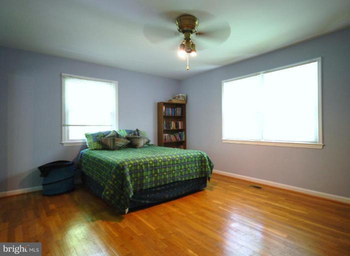 10728 Midsummer Drive Reston, VA 20191 - Photo 17 of 21 a living room with a bed furniture and a window