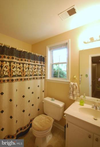 10728 Midsummer Drive Reston, VA 20191 - Photo 21 of 21 a bathroom with a sink toilet mirror and shower