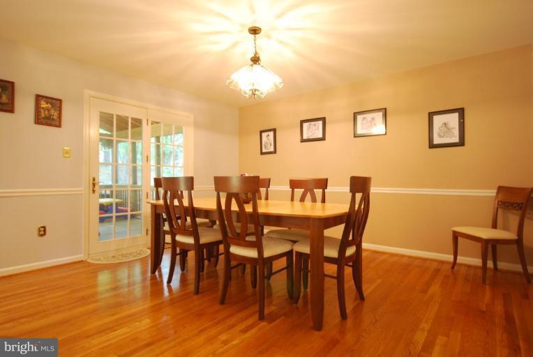 10728 Midsummer Drive Reston, VA 20191 - Photo 10 of 21 a view of a dining room with furniture and wooden floor