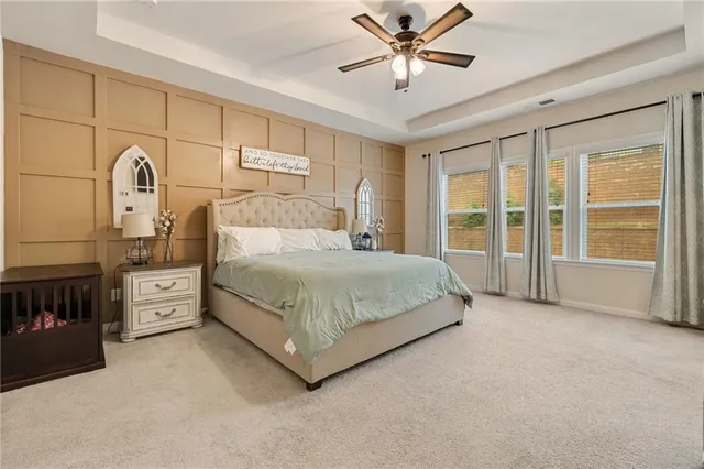 a spacious bedroom with a bed and a large window