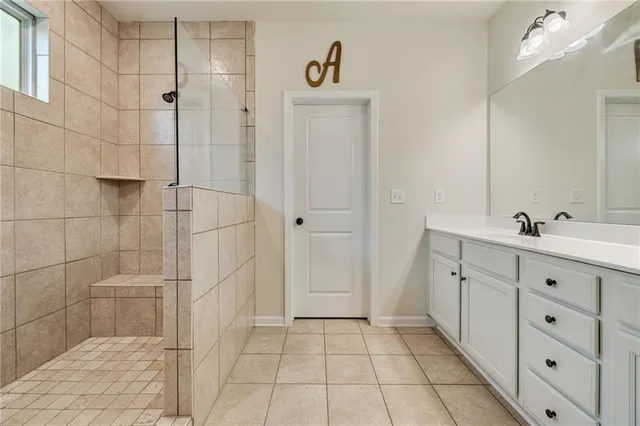 a bathroom with a double vanity sink a toilet and a shower