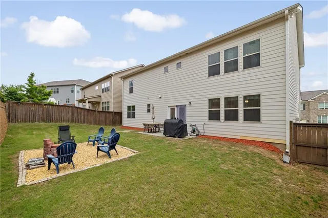 a backyard of a house with table and chairs