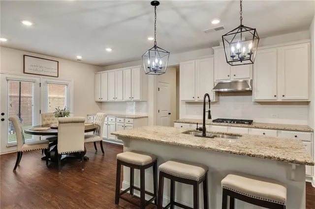 a kitchen with sink and refrigerator