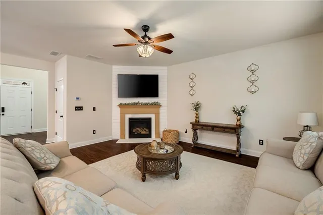 a living room with furniture and a fireplace