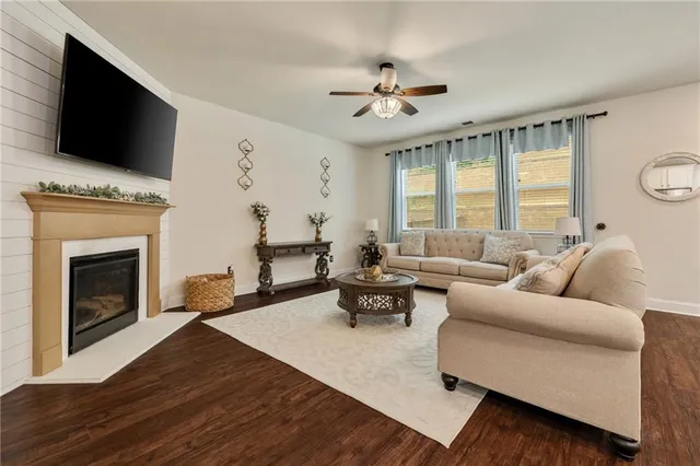 a living room with furniture fireplace and flat screen tv