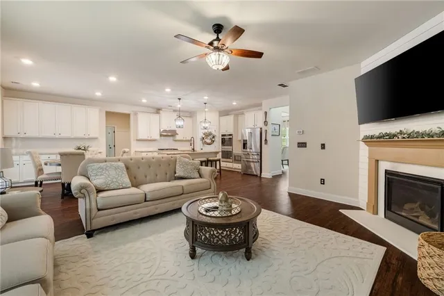 a living room with furniture a fireplace and a flat screen tv