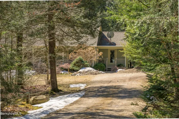 a view of a patio with a dining table and chairs with wooden floor