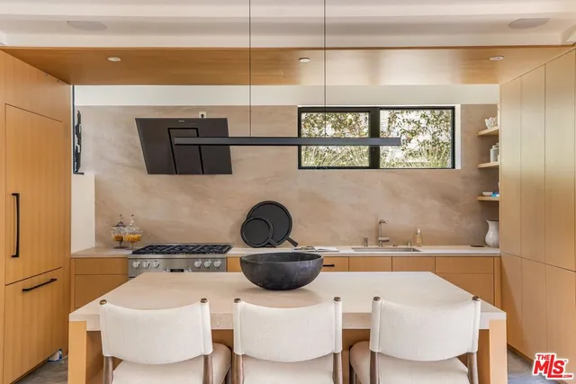 a kitchen with a sink a stove and a microwave