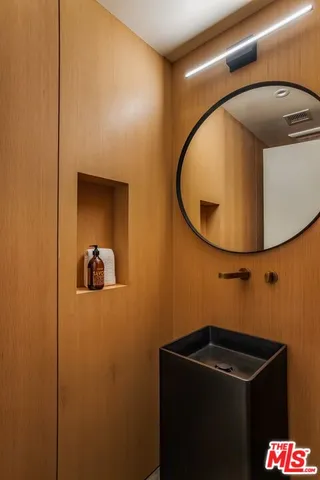 a bathroom with a sink and mirror